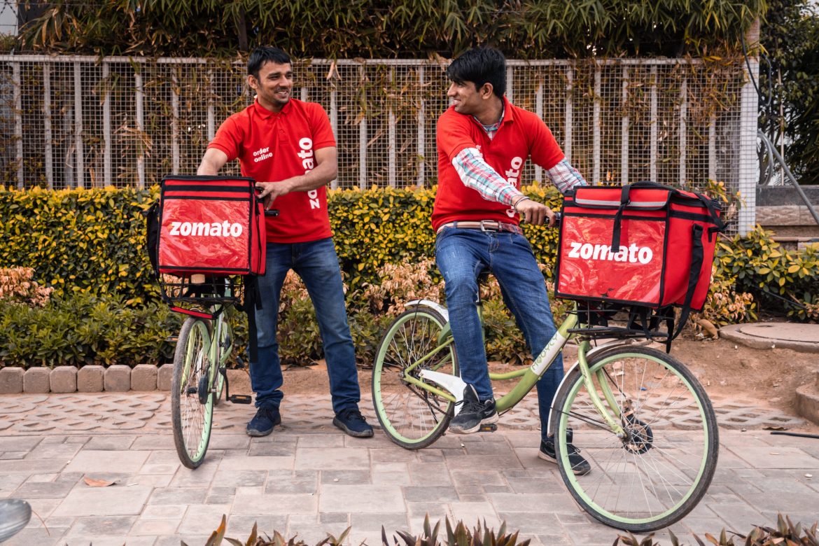 By <strong>Sarthak Goswami</strong>India’s gig economy has become a major job engine, driven by soaring demand for ultra-fast deliveries. The number of gig workers reached 12 million in FY 2024–25, up from 7.7 million in 2020–21, and could rise to 23.5 million by 2029–30, making up nearly 7% of the non-agricultural workforce.Quick-commerce alone was worth $3.34 billion in 2024, forecast to reach almost $10 billion by 2029. Platforms such as Blinkit, Zepto and Swiggy Instamart dominate this space: Blinkit processes 1.2 million daily orders (46% share), Zepto has 29%, and Instamart 25%. Together, these companies handle the majority of India’s quick-commerce orders, though competitors like BigBasket and Flipkart Minutes are scaling up.Reflecting this growth, Zomato (parent of Blinkit) and Jio Financial Services were added to India’s Nifty 50 index in March 2025, replacing Britannia and BPCL. Swiggy was added to the Nifty Next 50 during the same reshuffle. These inclusions underline growing investor confidence in the quick-commerce sector.In FY 2024–25, the sector’s gross order value stood at ₹64,000 crore, projected to rise to ₹2 lakh crore by FY28. This boom has created avenues for millions—yet for many delivery workers, earning a reliable income remains a challenge.Kashan: “I earn ₹800–1,200 a day”Kashan, who worked for Blinkit before moving to Zepto, says the job offers much-needed freedom.“There is no headache or pressure from anyone. You open the app, log in, select your time slot, and work during that time. For every order, you earn a fixed amount,” he explains.He says that part-time riders can make ₹800–1,200 a day, with a base payment per order plus additional pay for longer-distance deliveries. Payouts vary by city and time. “If I select a 7–8 pm slot and complete five orders, I can earn ₹100–150. But if I don’t go online for an elected slot, there is a penalty,” he notes.Blinkit revised its base payout to ₹15 per order in April 2023, a change that led to protests in Delhi-NCR and Pune. Incentives and distance-based payments now form a critical part of riders’ earnings.Zubair: “The first days were encouraging”Zubair joined Zepto just three days before being interviewed.“In the past three days, I have earned around ₹1,200 each day. If you have your own vehicle, it’s easier—but you can also lease an EV or an E-rickshaw. It does require hard work though because to earn more, you have to ride all day, whatever the weather,” he says.Platforms require minimal qualifications—just a smartphone and access to a bike or leased vehicle—which attracts both students and part-timers. Still, full-time riders often put in 12–15 hours per day to earn enough.Aakash: “Every kind of customer”Aakash, a rider for Swiggy Instamart, highlights the pressure from customer ratings.“Once, a customer scolded me and gave a low rating because I didn’t carry a small clip in a big paper bag. Ratings can affect your account, even if the issue is such a small matter,” he shares.Weather is another obstacle. “I want to earn more, so I ride even in heavy rain. Companies pay extra during those periods, but waterlogging makes it unsafe. Customers still expect delivery within minutes, which often isn’t possible,” he says.Aakash estimates his monthly earnings at around ₹30,000, working 9-10 hours a day, 5–6 days a week. He relies heavily on incentive pay and surge rates to boost his income.The more you work, the more you earnThese platforms pay per order, so income rises with order volume. Many riders put in long hours to reach targets set by apps. Yet missing an elected slot or getting low ratings can bring penalties. Full-time partners often work in 12–15 hour shifts, especially during peak hours or festivals.One survey found that 56% of workers report high job satisfaction due to flexibility and the ability to work across platforms, while 78% still earn less than ₹2.5 lakh a year. These figures highlight the income gap for a large share of India’s delivery workforce.Worker protests and slow policy changeDelivery partners across platforms have staged several protests demanding better pay and safety. Blinkit riders struck in April 2023 after pay cuts and again in April 2025 in Varanasi, pressing for heatwave-ready uniforms and shaded waiting areas. Workers report that account suspensions are common during such actions.Similar protests have occurred at Swiggy and Zomato in cities like Chennai, Kolkata and Bengaluru since 2019. Zomato introduced resting points for delivery workers in 2023 and reversed a fleet segregation plan after public backlash. Urban Company cut partner commissions and penalties following protests in 2021.At the state level, Rajasthan passed the Gig Workers (Registration & Welfare) Act in 2023. Telangana announced a ₹5 lakh accident insurance plan in 2024, though reports indicate the coverage lapsed and has yet to be renewed. Karnataka formalised its platform-based gig workers bill in 2025, bringing mandatory insurance coverage. However, no national law guarantees minimum pay or job security, and state-level implementation remains uneven.The future of delivery workAs Amazon Now and Flipkart Minutes enter the space, quick-commerce companies are ramping up competition. Analysts expect gross order value to reach ₹2 lakh crore by FY28, tripling in three years.Delivery jobs continue to draw workers seeking flexibility—more than half of them report being satisfied with their work. But most earn under ₹2.5 lakh a year and rely heavily on incentives, facing uncertainties like rating penalties and earnings volatility.As Kashan says, “If you want to earn ₹30,000–40,000 a month on your own schedule, delivery work is a good option.” But with gig employment projected to reach 23.5 million by 2029–30, questions about long-term sustainability remain.(<em>Sarthak Goswami is an intern at Invezz in New Delhi, currently pursuing a BA (Hons) in Journalism from Maharaja Agrasen College, University of Delhi. He specialises in geopolitics, the economy, and new media, and is also the founder and editor of Beats in Brief and Queats Media.</em>)The post <a href="https://invezz.com/news/2025/08/06/gig-workers-power-indias-12m-strong-quick-commerce-boom-but-are-they-really-winning/">Gig workers power India’s 12M strong quick-commerce boom: but are they really winning?</a> appeared first on <a href="https://invezz.com/">Invezz</a>